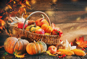 Thanksgiving pumpkins with fruits and falling leaves